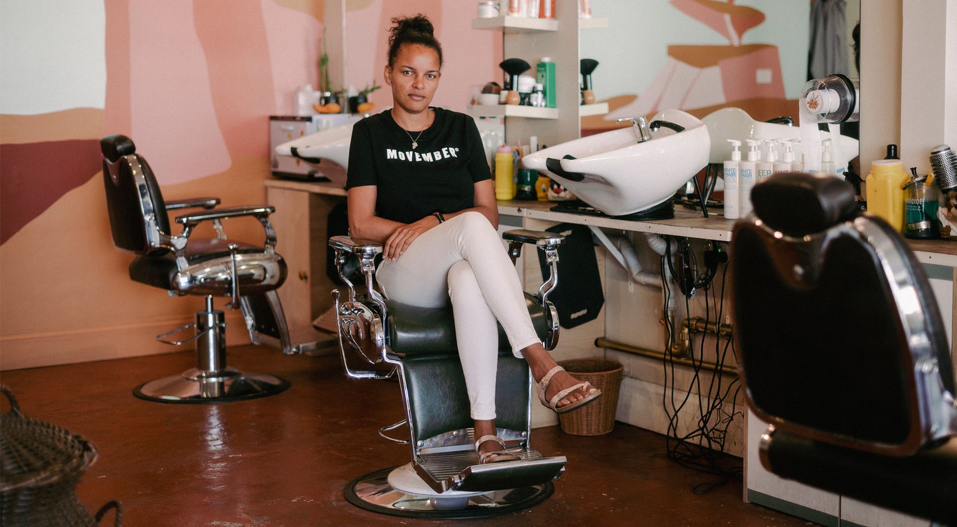 Mo Sister Sheila in a barber chair.